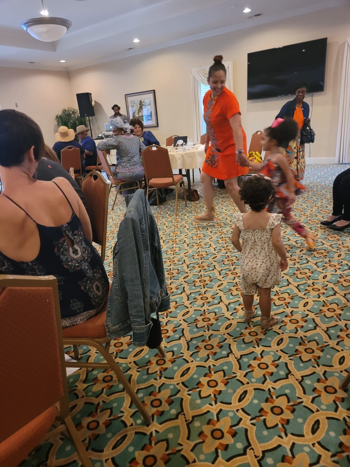 Toddler dancing in orange dress