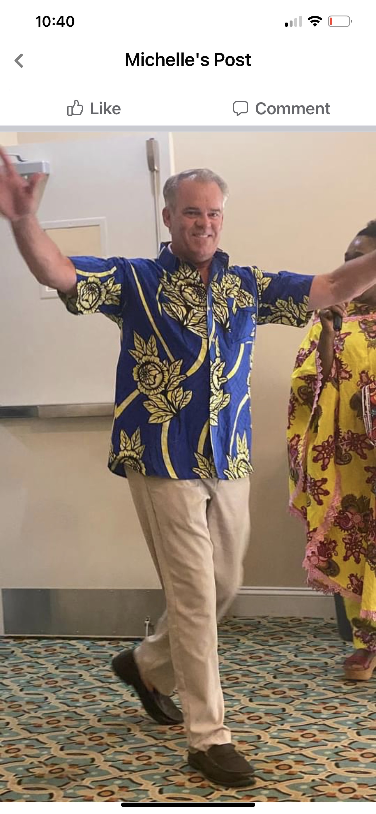 Man dancing in African print shirt