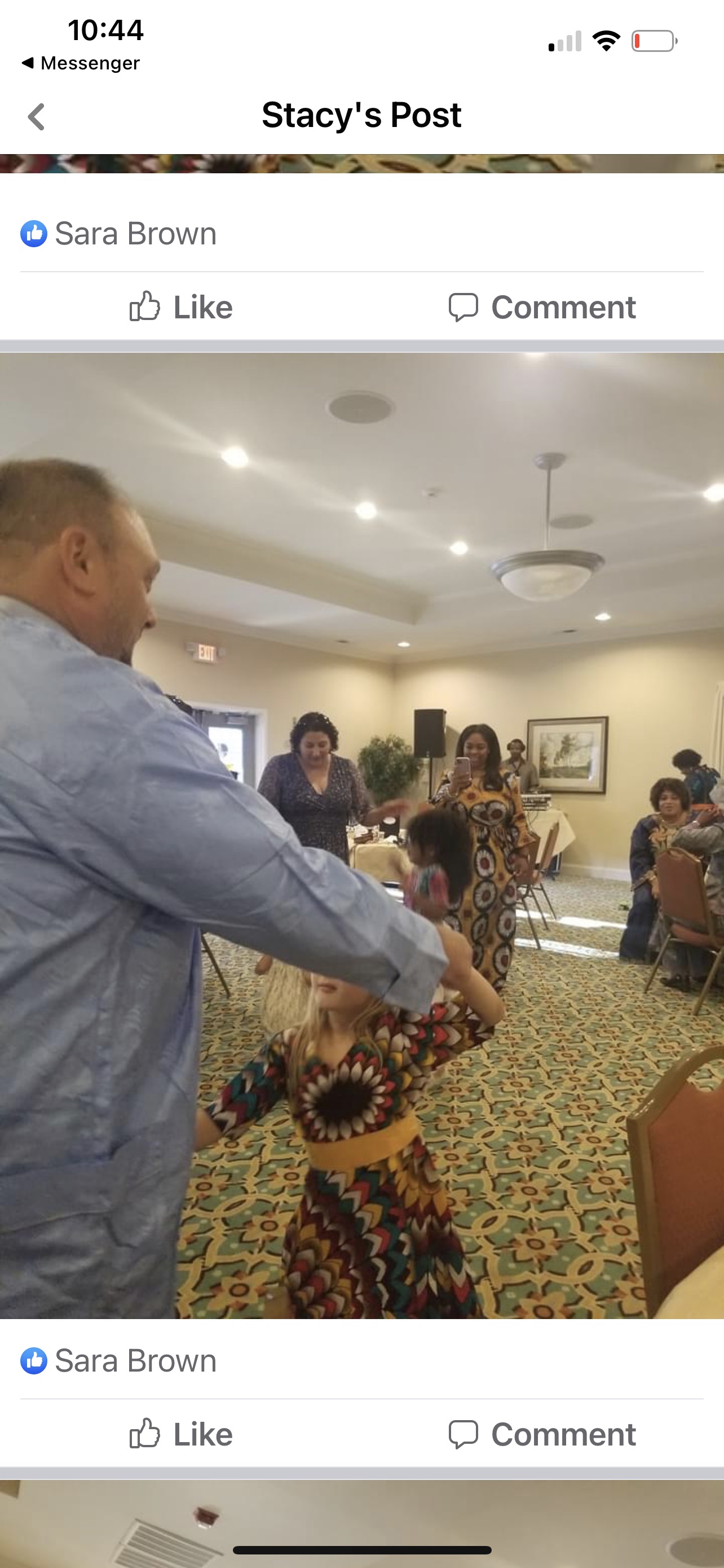 Man dancing with child at event