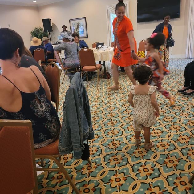 Toddler dancing in orange dress
