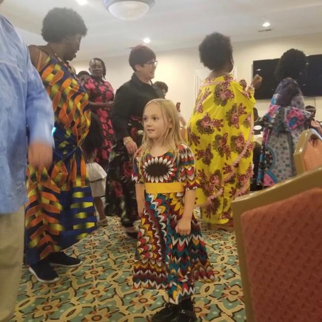 Girl in African dress among crowd
