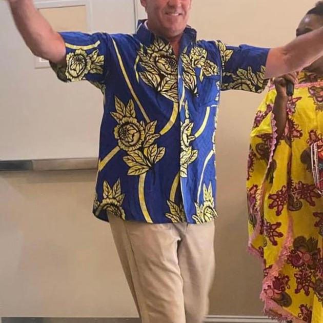Man dancing in African print shirt