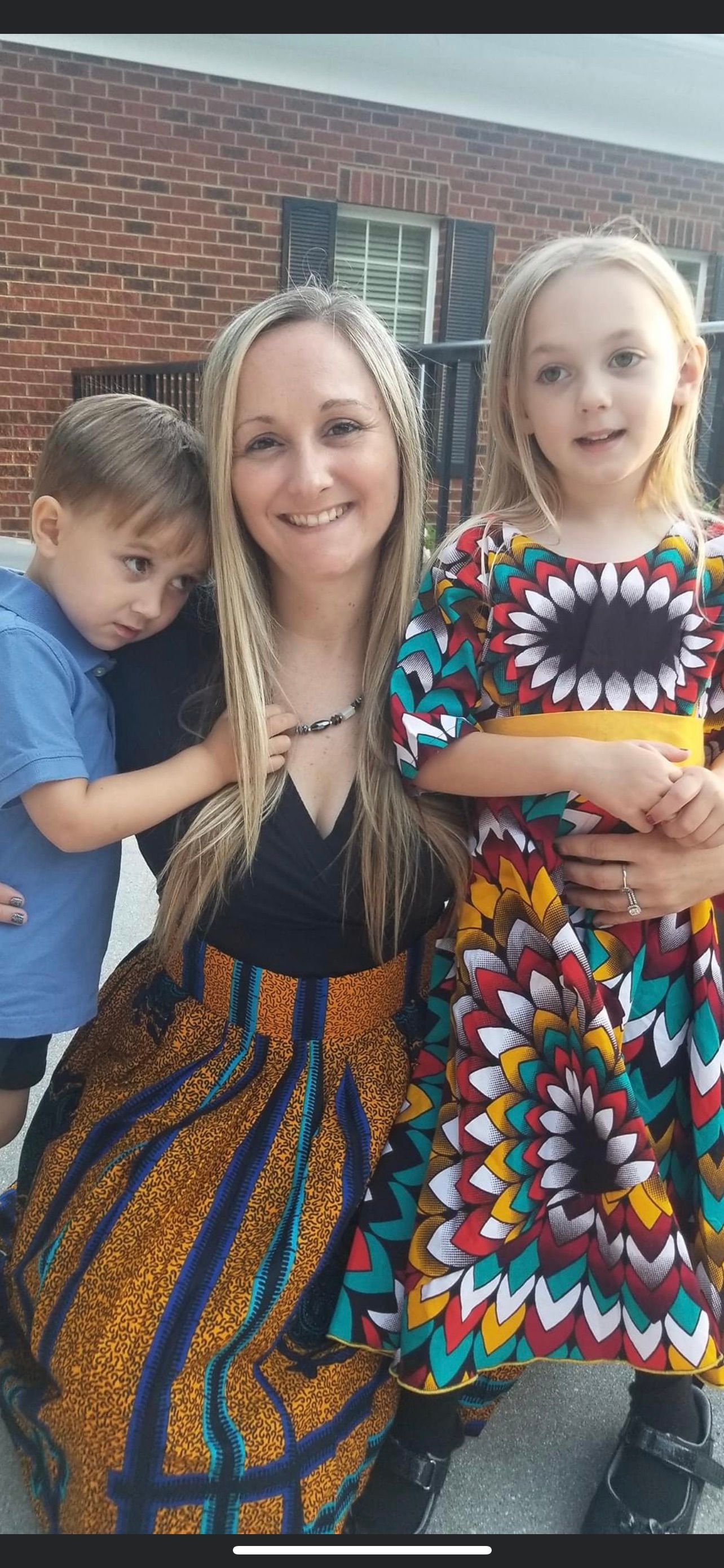 Mom and kids in African outfits outdoors
