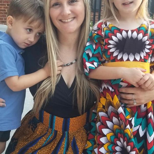 Mom and kids in African outfits outdoors